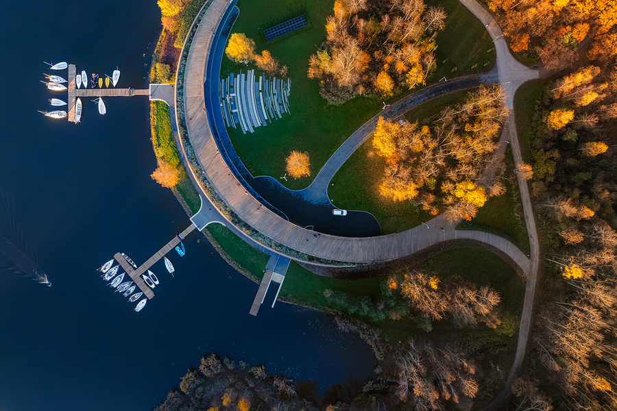 Marina żeglarska nad Jeziorem Paprocańskim w Tychach z lotu ptaka. Nowoczesna architektura i jesienne drzewa. Czas wolny w Górnośląsko-Zagłębiowskiej Metropolii.